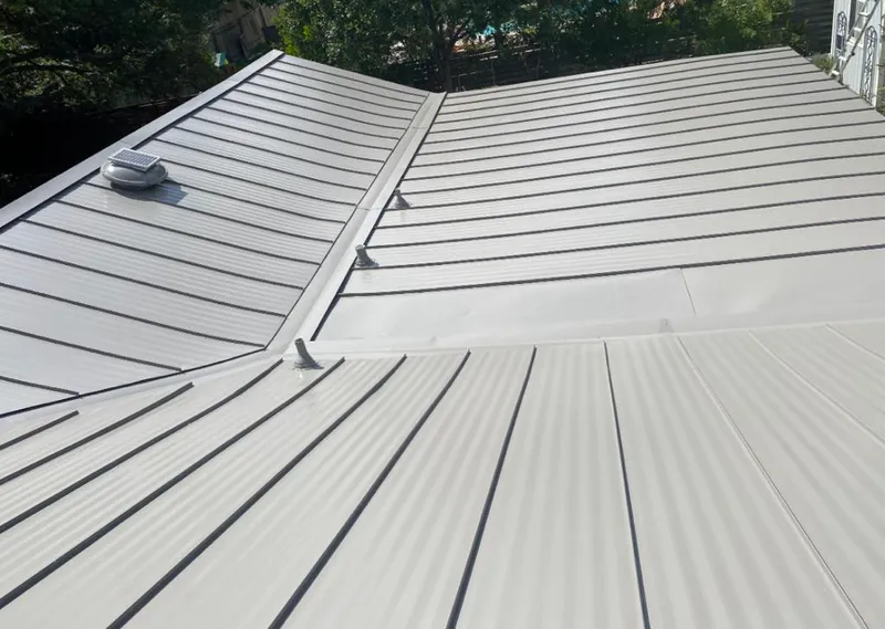 Solar attic fan installed on a metal roof for Roof Ventilation in Chicago Ridge